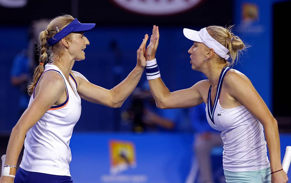 Russia's Ekaterina Makarova, left, and Elena Vesnina celebrate a point won over Italy's Sara Errani and Roberta Vinci during their women's doubles final at the Australian Open tennis championship in Melbourne.