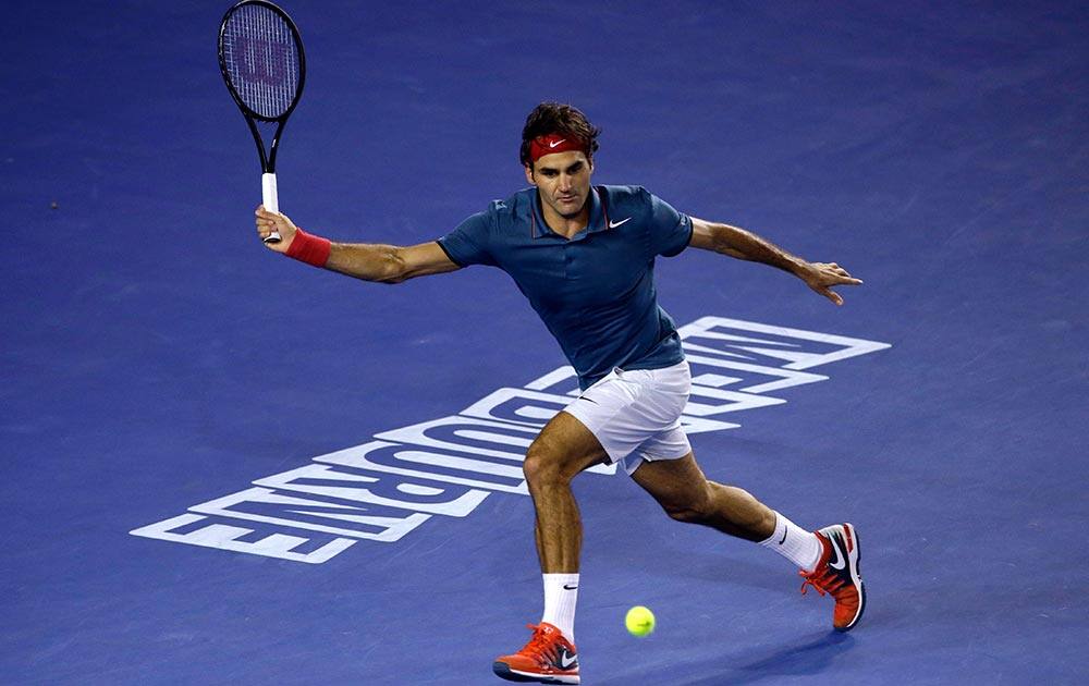 Roger Federer of Switzerland chases a ball for a return shot to Rafael Nadal of Spain during their semifinal at the Australian Open tennis championship in Melbourne.