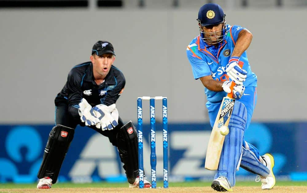MS Dhoni bats in front of New Zealand's Luke Ronchi in their third one day international cricket match at Eden Park in Auckland.