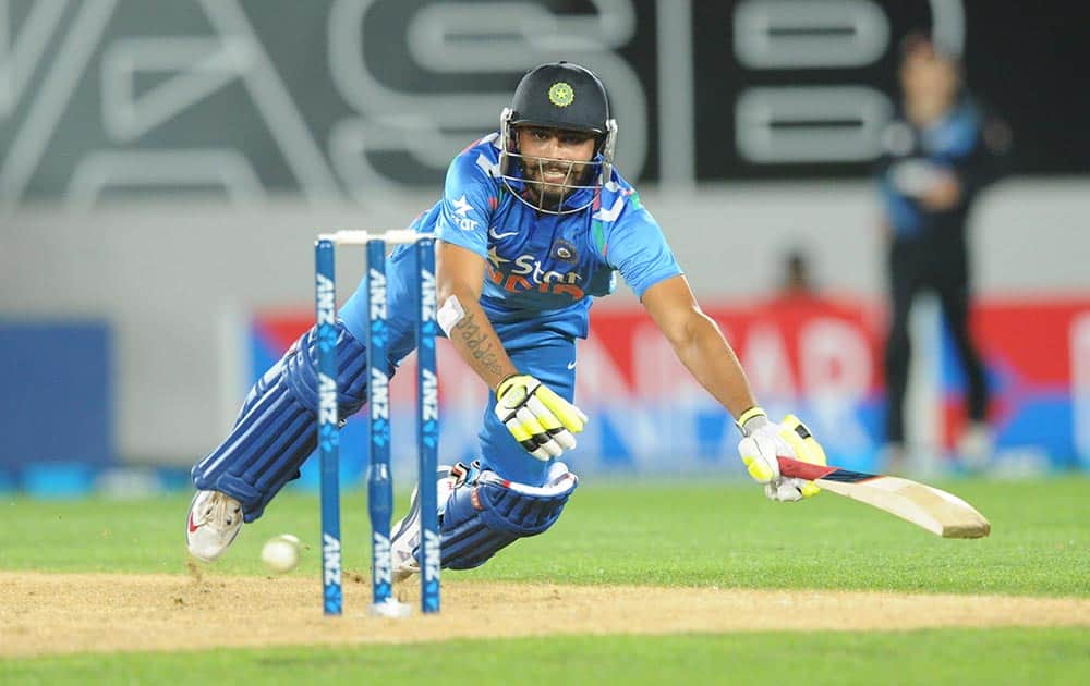 Ravindra Jadeja dives to make his ground against New Zealand during the third one day International cricket match at Eden Park in Auckland.