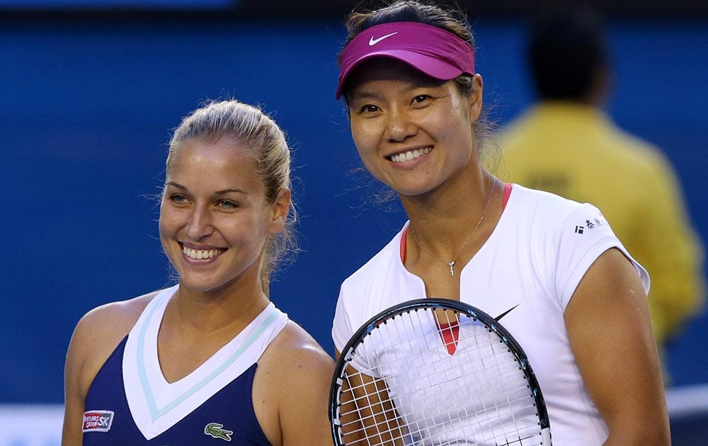 Li Na of China, right, and Dominika Cibulkova of Slovakia pose for a photo at the net, prior to their women's singles final at the Australian Open tennis championship in Melbourne, Australia.
