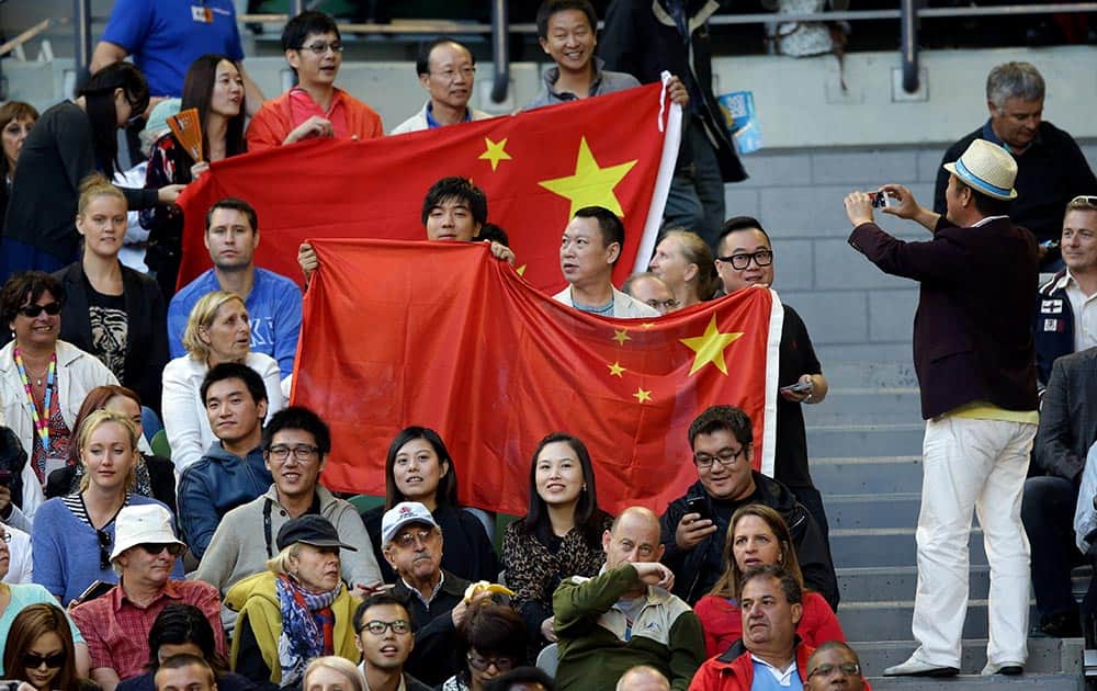 Supporters of China's Li Na hold Chinese flags as Li plays Dominika Cibulkova of Slovakia during their women's singles final at the Australian Open tennis championship in Melbourne.