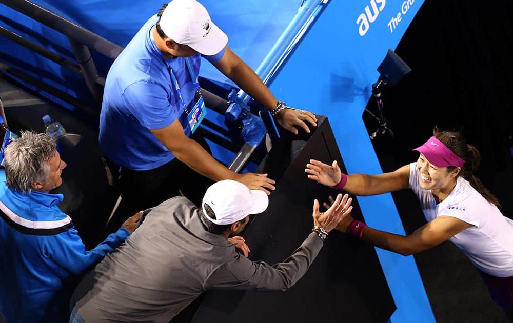 Li Na of China celebrates with her husband Jiang Shan, center top, and support team members after defeating Dominika Cibulkova of Slovakia during their women's singles final at the Australian Open tennis championship in Melbourne.