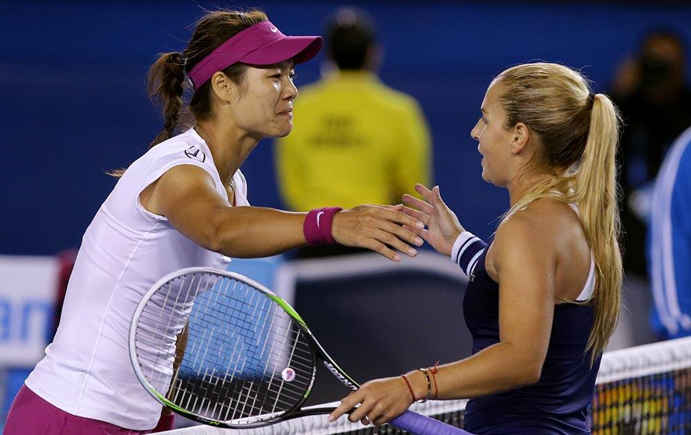 Li Na of China, left, shakes hands with Dominika Cibulkova of Slovakia at the net after Li won their women's singles final at the Australian Open tennis championship in Melbourne.