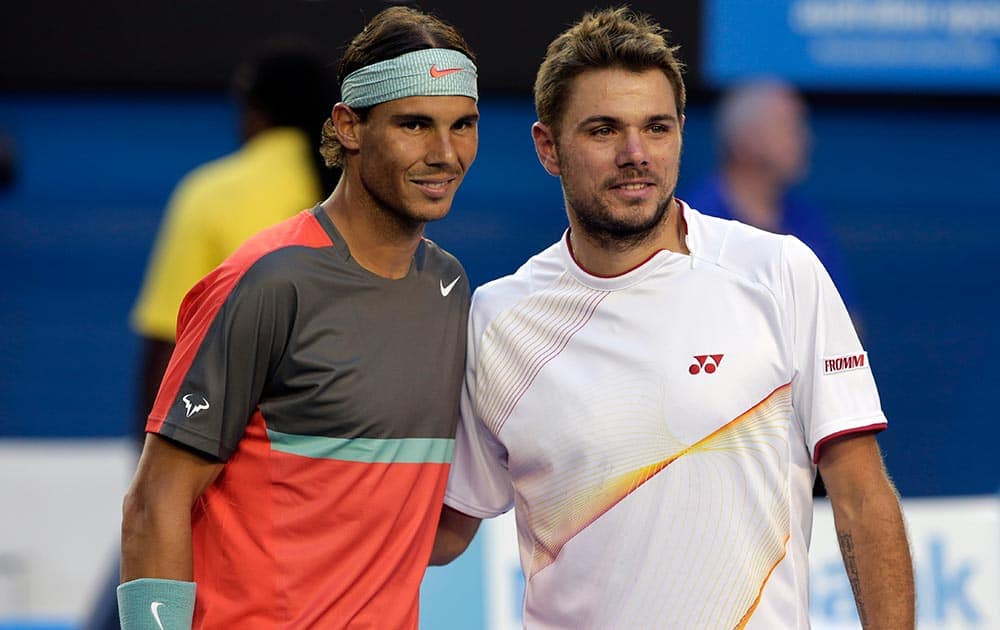 Rafael Nadal of Spain, left, and Stanislas Wawrinka of Switzerland pose for a photo at the net before their men's singles final at the Australian Open tennis championship in Melbourne.