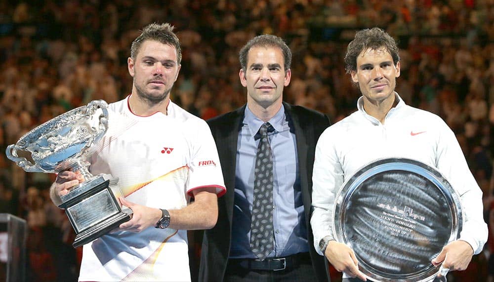 Stanislas Wawrinka of Switzerland, left, holds the trophy with runner-up Rafael Nadal of Spain, right, and former world No.1 Pete Sampras, after his win in their men's singles final at the Australian Open tennis championship in Melbourne.