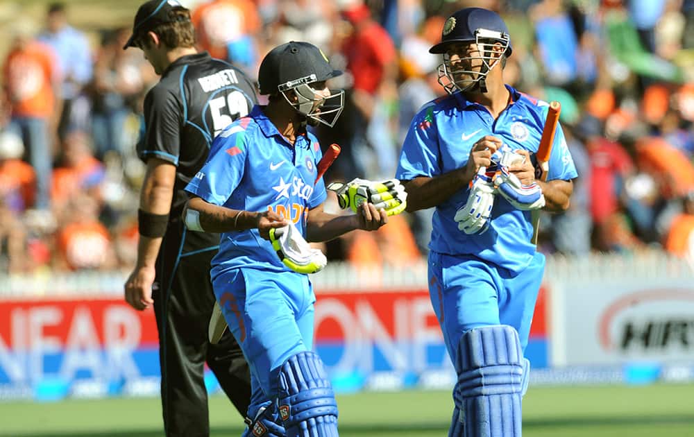 India’s Ravindra Jadeja and MS Dhoni leave the pitch at the end of their innings of 278 against New Zealand during their fourth one-day international cricket match, at Seddon Park, in Hamilton, New Zealand.