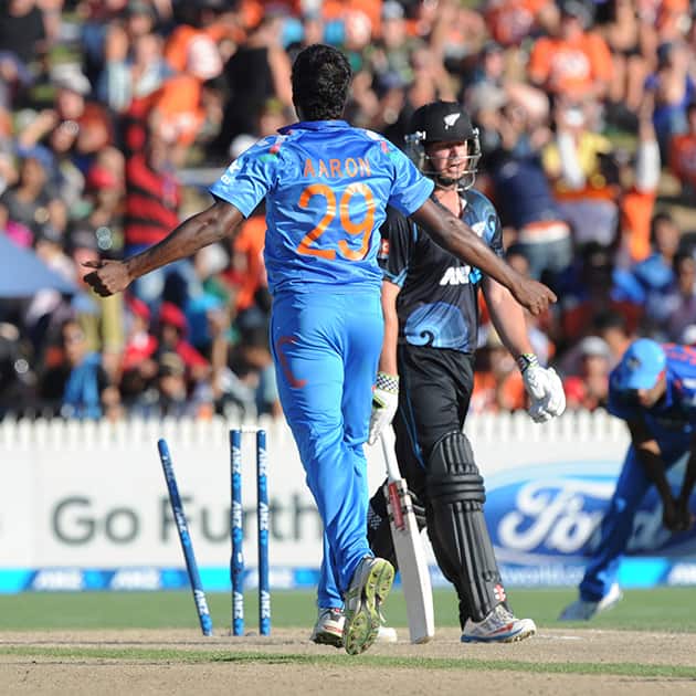 India's Varun Aaron celebrates after bowling out New Zealand's Jesse Ryder for 19 during the fourth one day International cricket match at Seddon Park in Hamilton, New Zealand.