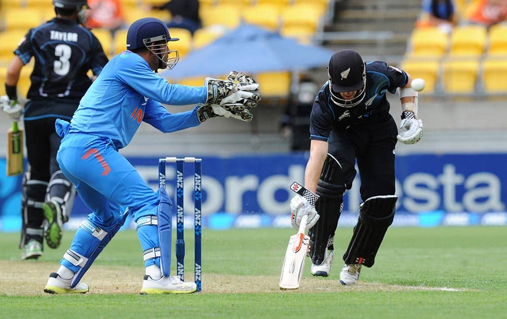 New Zealand's Kane Williamson, right, makes his ground as the ball is returned to India’s wicketkeeper MS Dhoni in the fifth and final one-day international cricket match in Wellington.