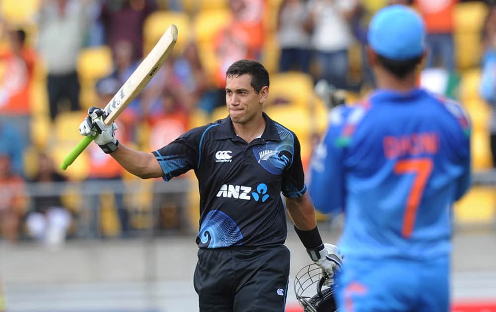 New Zealand's Ross Taylor is applauded by India’s MS Dhoni on reaching his century in the fifth and final one-day international cricket match in Wellington, New Zealand.