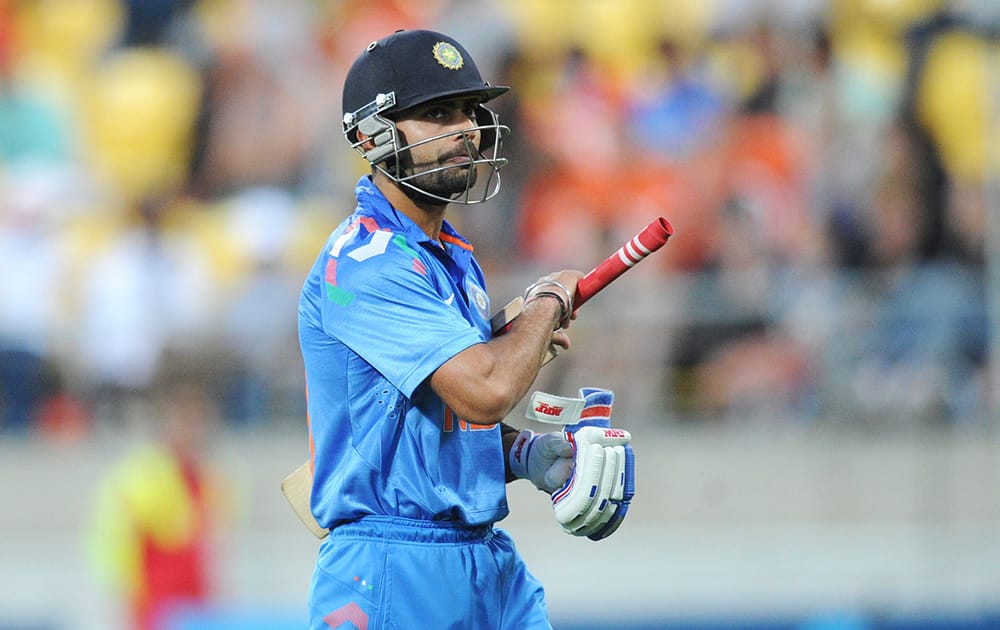 India’s Virat Kohli walks, out for 82 off the bowling of New Zealand's Nathan McCullum during the fifth one day International cricket match at Westpac Stadium in Wellington, New Zealand.