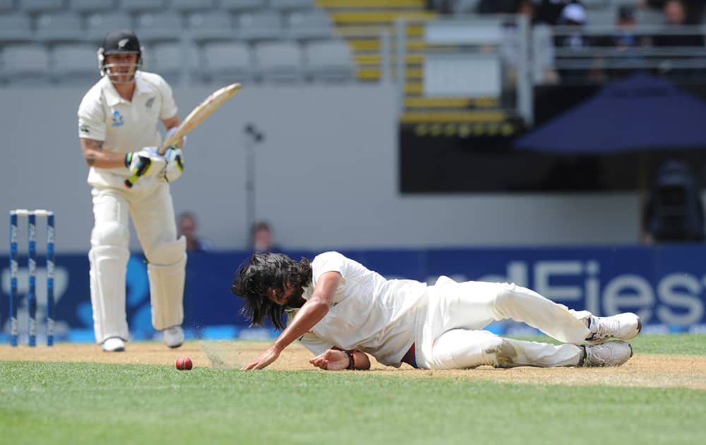 India’s Ishant Sharma dives to save the ball off the bat of New Zealand’s Brendon McCullum on the first day of the first cricket test at Eden Park in Auckland, New Zealand.