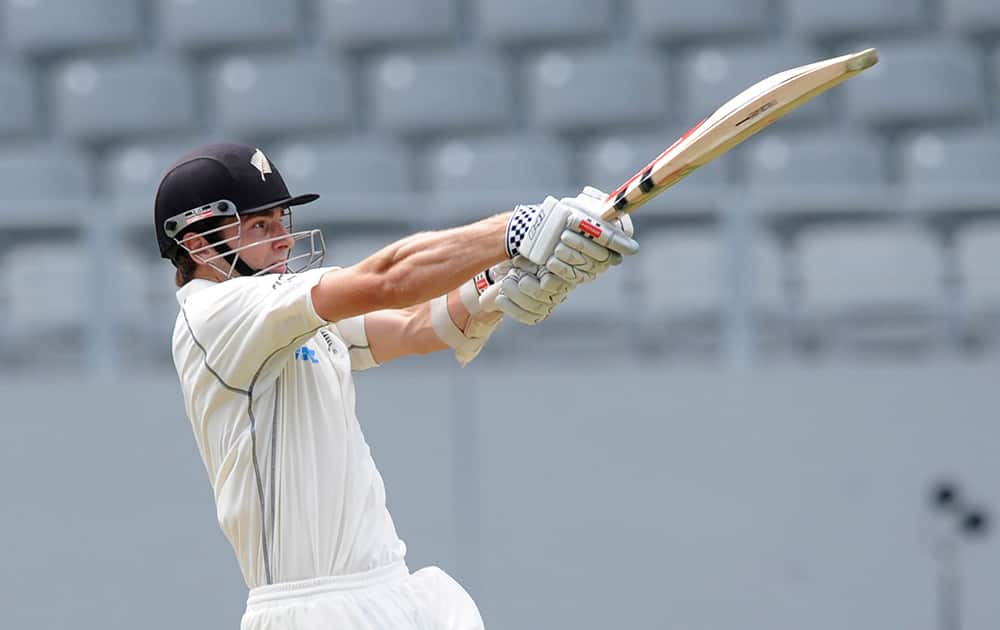 New Zealand’s Kane Williamson hits a six to the boundary against India on the first day of the first cricket test at Eden Park in Auckland, New Zealand.