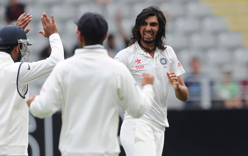 India’s Ishant Sharma, right, celebrates with team mates after dismissing New Zealand’s Ross Taylor for 3 in the first cricket test at Eden Park in Auckland, New Zealand.