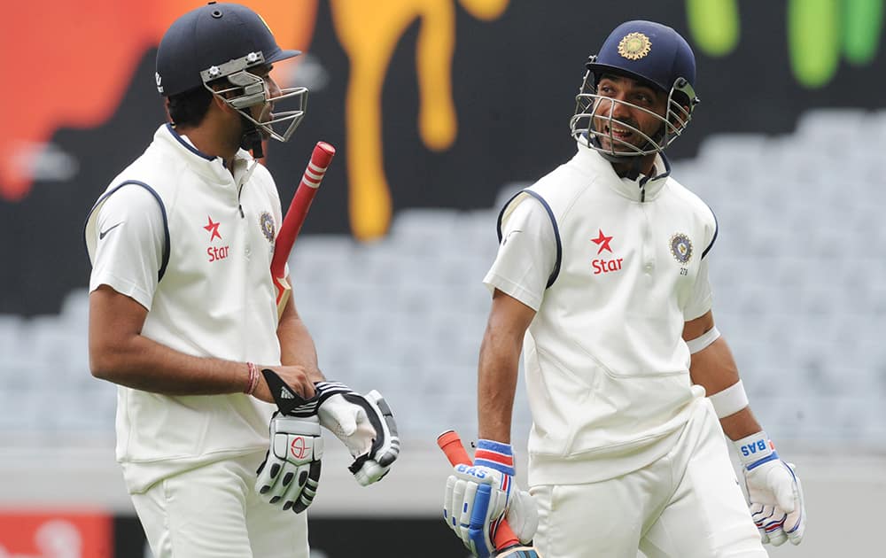 India’s Rohit Sharma, left, and India’s Ajinkya Rahane leave the pitch after the umpires called bad light against New Zealand on the second day of the first cricket test at Eden Park in Auckland, New Zealand.