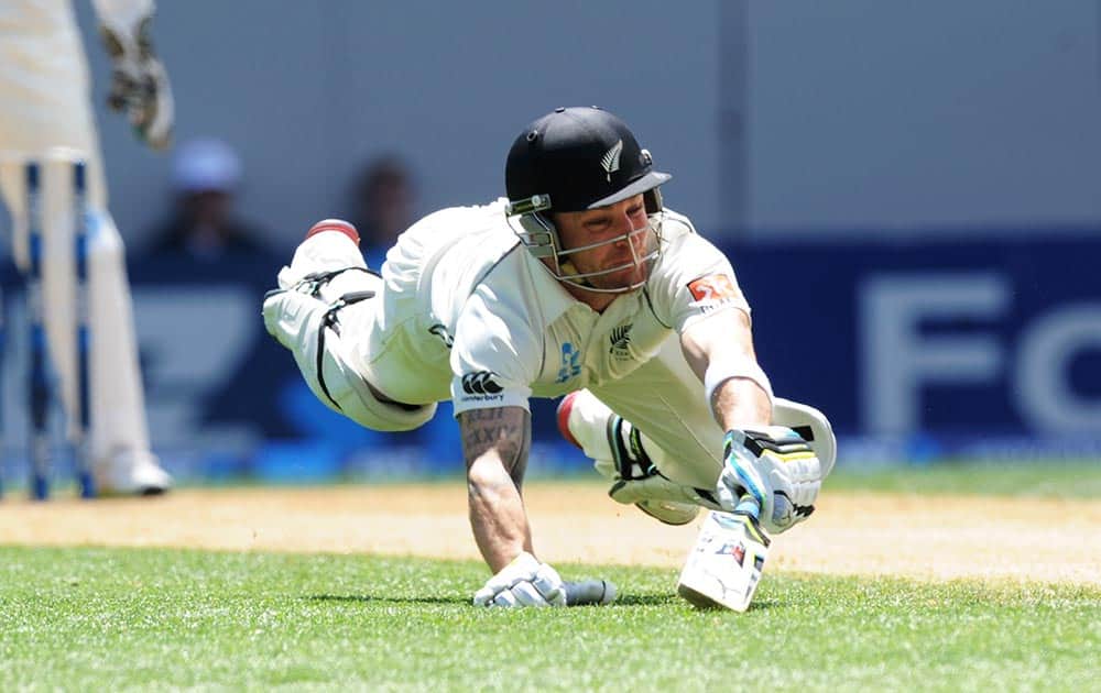 New Zealand’s Brendon McCullum dives, but fails to make his ground and is run out for 1 against India on the third day of the first cricket test, at Eden Park in Auckland.