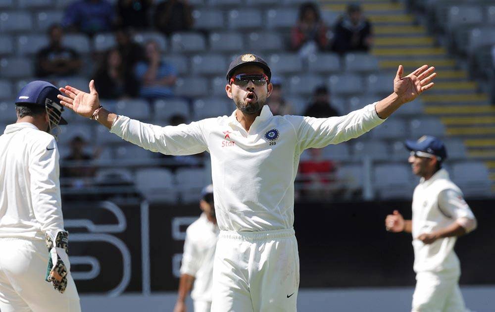 Virat Kohli reacts to the crowd after the wicket of New Zealand’s Tim Southee fell for 14 on the 3rd day of the 1st cricket test at Eden Park in Auckland.