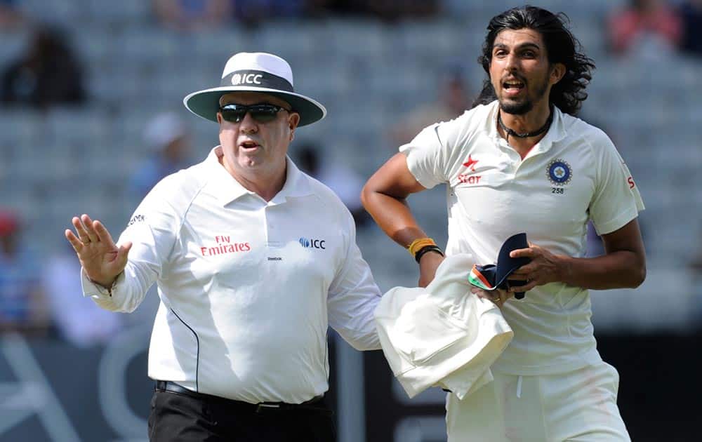 Umpire Steve Davis, left, attempts to cool a war of words between departing batsman New Zealand’s Neil Wagner and India’s Ishant Sharma at the end of the New Zealand 2nd innings on the third day of the first cricket test at Eden Park in Auckland, New Zealand.