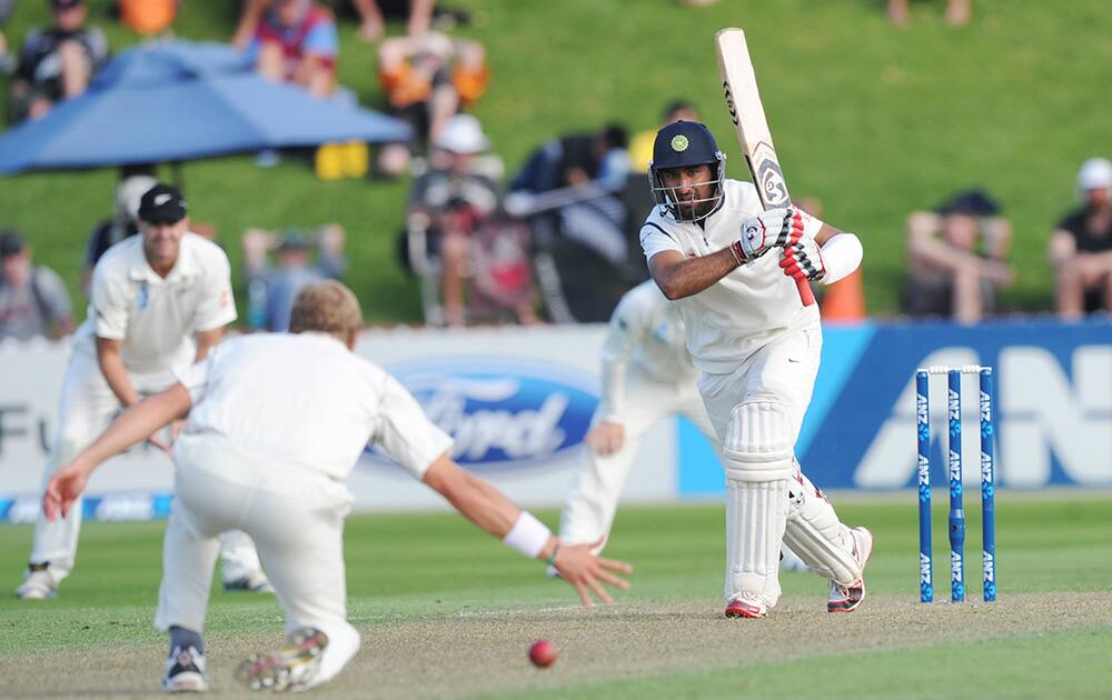 India’s Cheteshwar Pujara bats the ball pats New Zealand’s Neil Wagner on the first day of the second cricket test in Wellington, New Zealand.