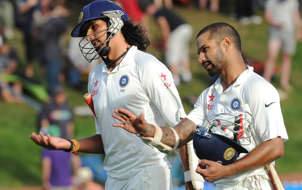 India’s Ishant Sharma and Shikar Dhawan leave the pitch at the end of play against New Zealand on the first day of the second cricket test in Wellington, New Zealand.