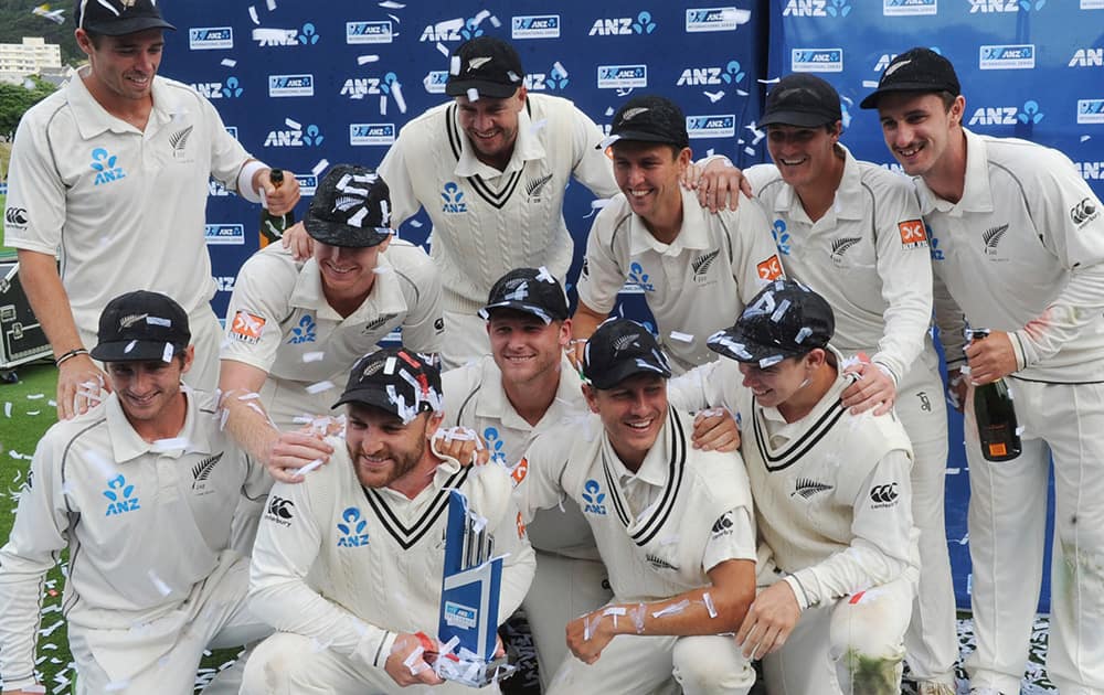 New Zealand team members celebrate their series win over India on the final day of the second test at the Basin Reserve in Wellington, New Zealand.