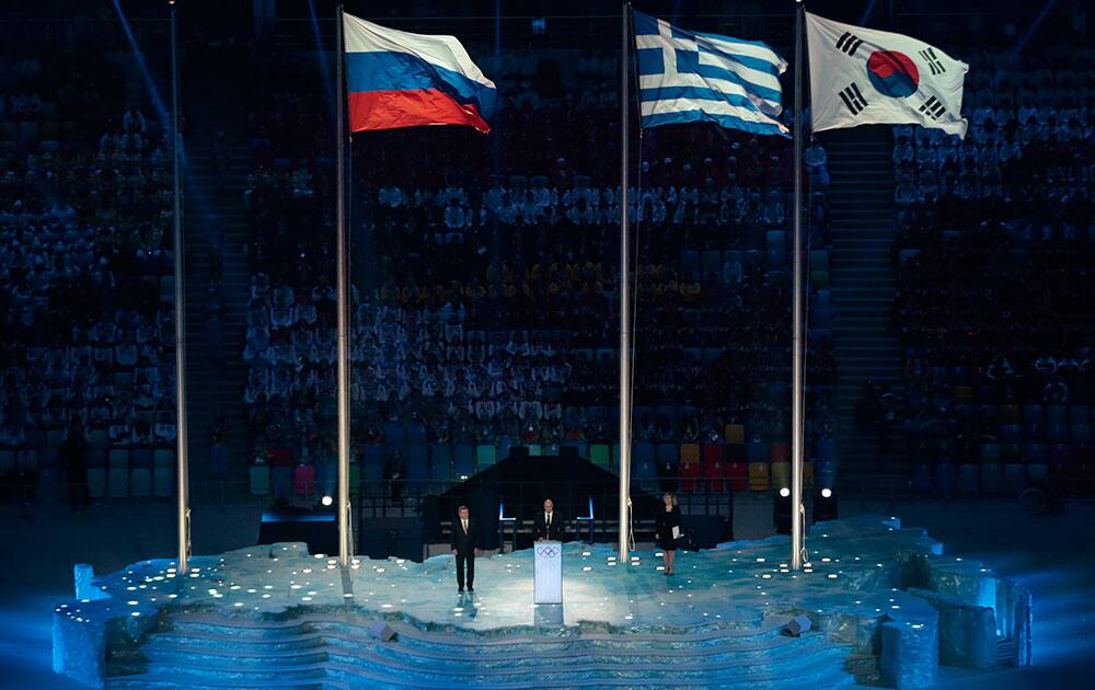 President and CEO of the Sochi 2014 Organizing Committee Dmitry Chernyshenko, center, speaks as International Olympic Committee President Thomas Bach, left, listens during the closing ceremony of the 2014 Winter Olympics.