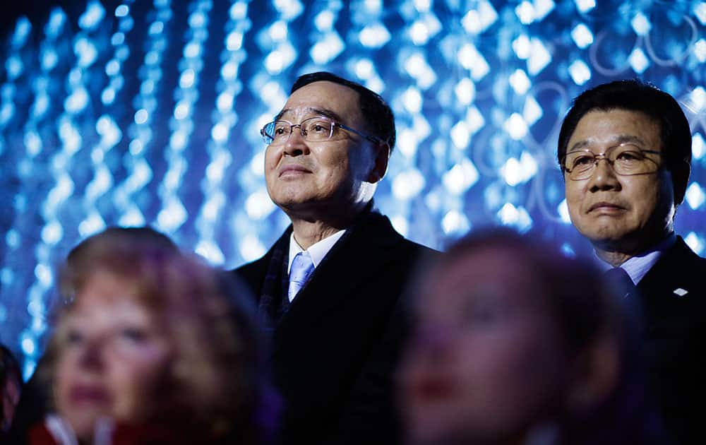 South Korean Prime Minister Chung Hong-won, left, and Kim Jin-sun, head of the Pyeongchang Organizing Committee for the 2018 Winter Olympics, watch the closing ceremony for the 2014 Winter Olympics.