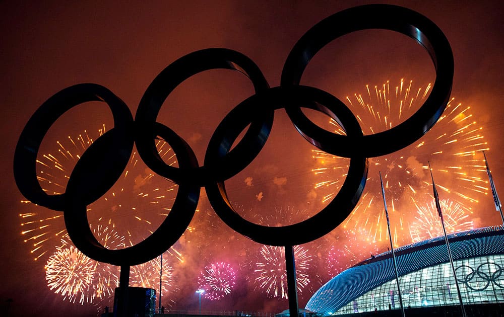 The Olympic Rings are silhouetted as fireworks light up the sky during the closing ceremonies at the 2014 Sochi Winter Olympics.