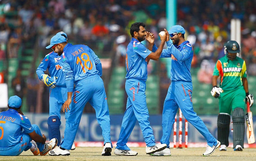 Mohammad Shami, center with a ball, celebrates with teammates for the dismissal of Bangladeshi Shamsur Rahman during the Asia Cup one-day international cricket tournament in Fatullah, near Dhaka, Bangladesh.