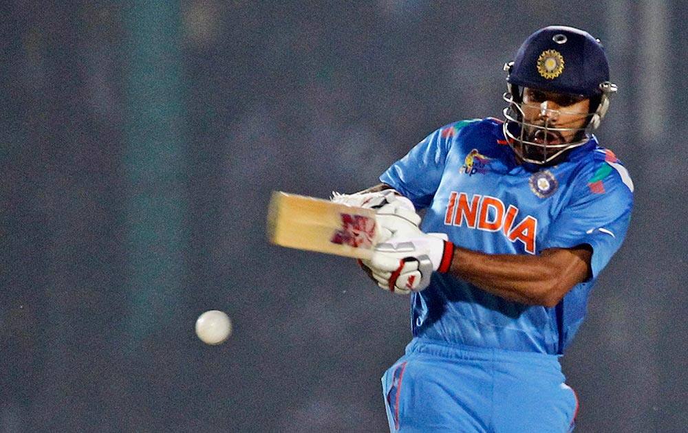 India’s Shikhar Dhawan plays a shot during the Asia Cup one-day international cricket tournament against Bangladesh in Fatullah, near Dhaka, Bangladesh.