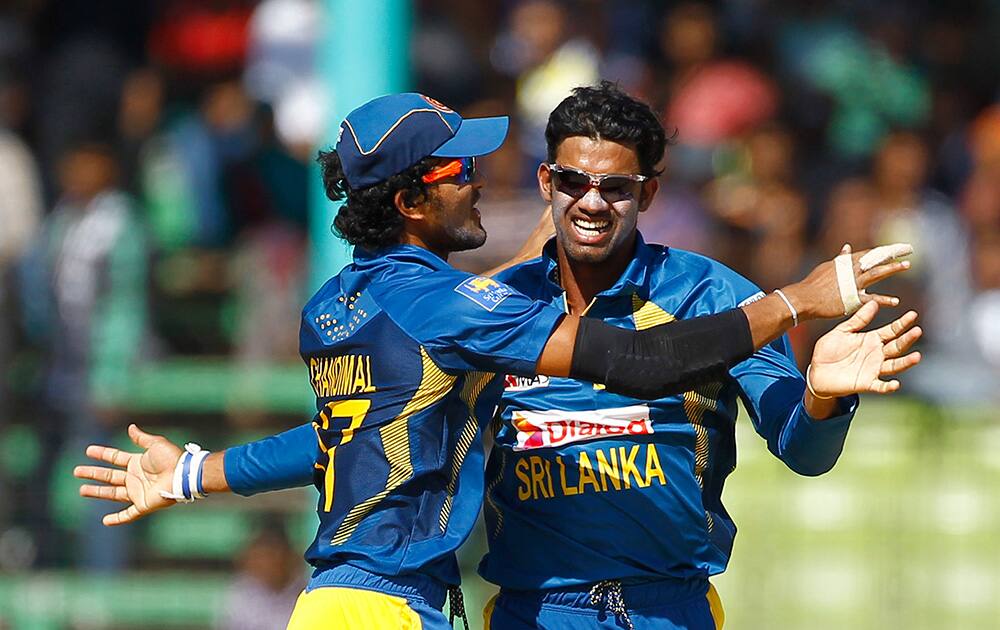 Sri Lanka’s Sachithra Senanayake celebrates with his teammate Dinesh Chandimal dismissal of India’s Rohit Sharma during the Asia Cup one-day international cricket tournament, in Fatullah, near Dhaka, Bangladesh.