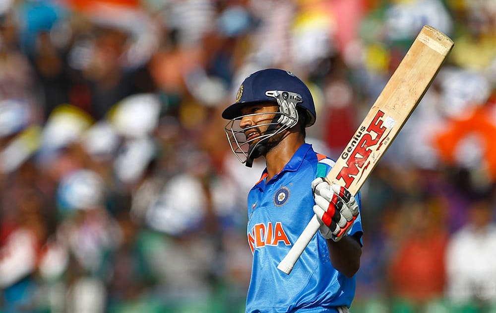 India’s Shikhar Dhawan acknowledges the crowed after scoring fifty runs during the Asia Cup one-day international cricket tournament against Sri Lanka in Fatullah, near Dhaka, Bangladesh.
