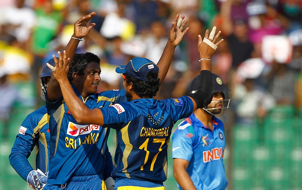 Sri Lanka’s Ajantha Mendis celebrates with his teammates the wicket of India’s Virat Kohli during the Asia Cup one-day international cricket tournament in Fatullah, near Dhaka, Bangladesh.