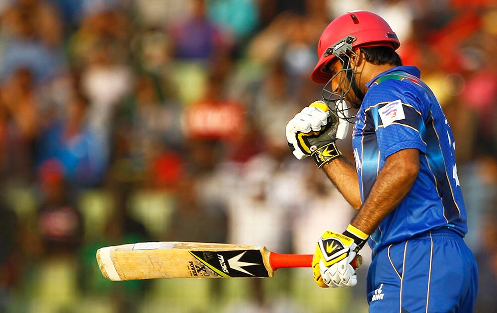 Afghanistan’s Asghar Stanikzai celebrates after scoring fifty runs during the Asia Cup one-day international cricket tournament against Bangladesh in Fatullah, near Dhaka, Bangladesh.