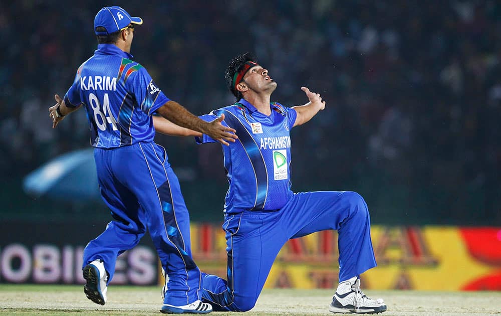 Afghanistan’s Hamid Hassan, right, and his teammate Karim Sadiq celebrate the wicket of Bangladesh’s Anamul Haque during the Asia Cup one-day international cricket tournament in Fatullah, near Dhaka, Bangladesh.