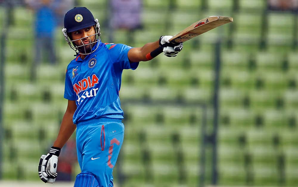 India’s Rohit Sharma raises his bat after scoring fifty against Pakistan during the Asia Cup one-day international cricket tournament between them in Dhaka, Bangladesh.