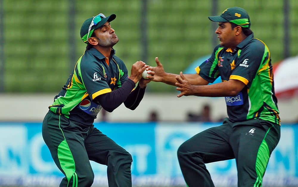 Pakistan’s Mohammad Hafeez, left, successfully catches the ball to dismiss India’s Rohit Sharma during the Asia Cup one-day international cricket tournament between them in Dhaka, Bangladesh.