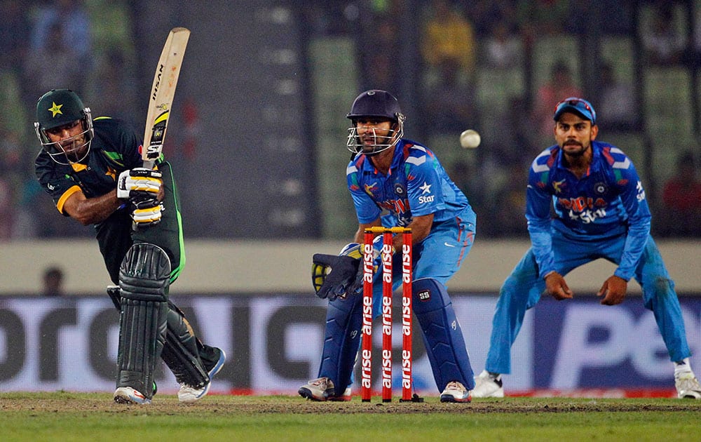 Pakistan’s Mohammad Hafeez, left, plays a shot during the Asia Cup one-day international cricket tournament against India in Dhaka.