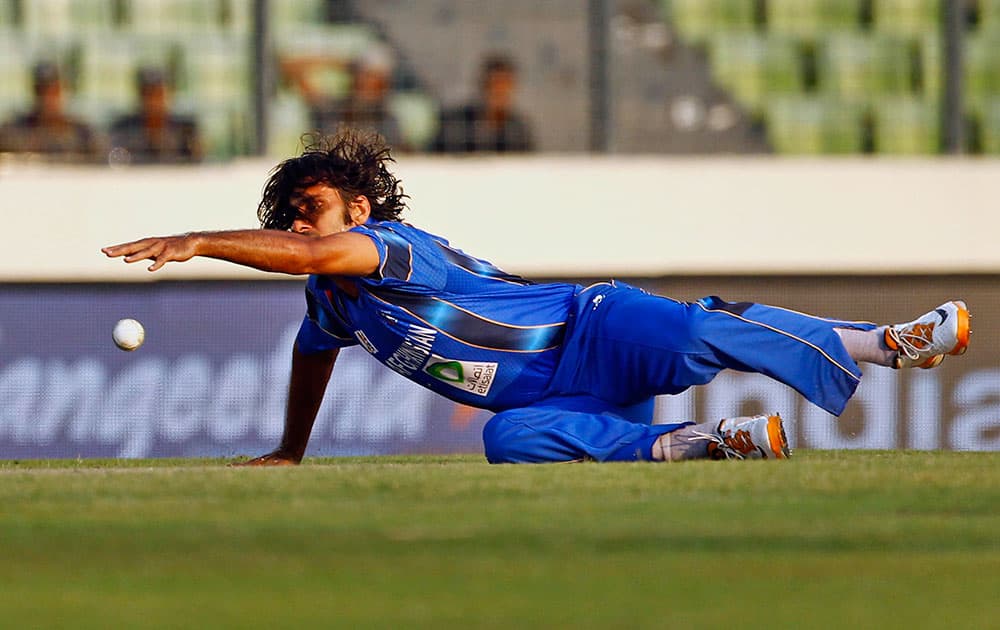 Afghanistan’s Shapoor Zadran dives to field the ball during the Asia Cup one-day international cricket tournament against Sri Lanka in Dhaka.