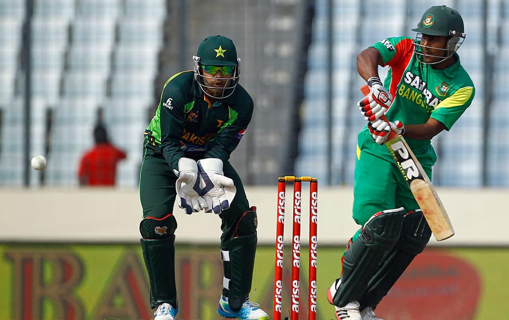 Bangladeshi cricket player Imrul Kayes, right, bats as Pakistan’s wicketkeeper Umar Akmal watches during the Asia Cup one-day international cricket tournament in Dhaka.