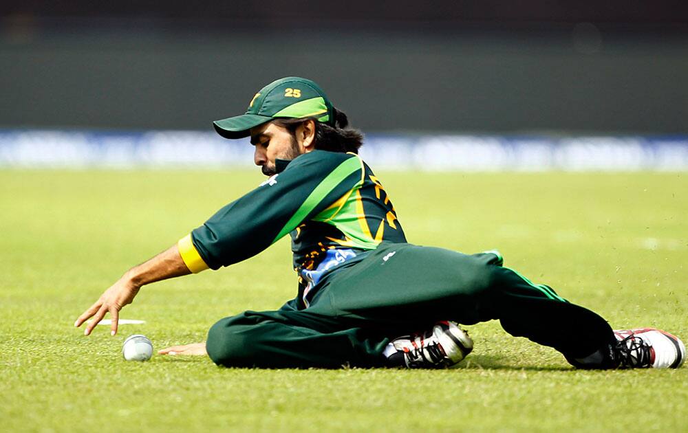 Pakistan’s Fawad Alam dives to catch the ball as he fields against Bangladesh during their Asia Cup one-day international cricket tournament in Dhaka.