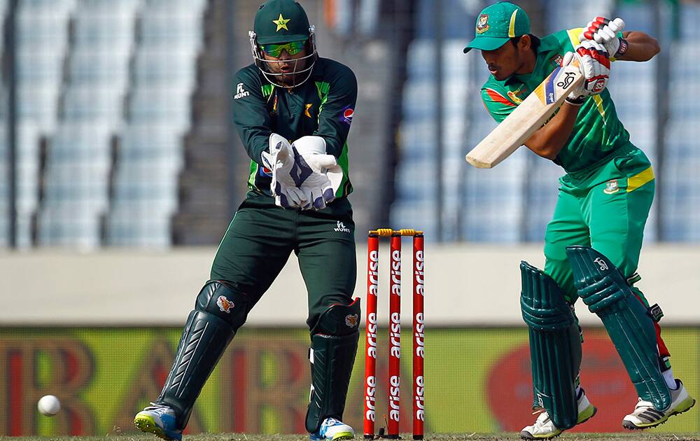 Bangladesh's Anamul Haque, right, bats in front of Pakistan’s wicketkeeper Umar Akmal during their Asia Cup one-day international cricket tournament in Dhaka, Bangladesh.