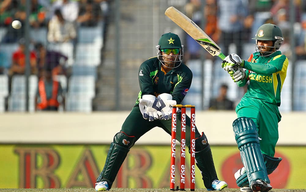 Bangladesh’s Mominul Haque, right, plays a shot, as Pakistan’s wicketkeeper Umar Akmal watches during the Asia Cup one-day international cricket tournament in Dhaka, Bangladesh.