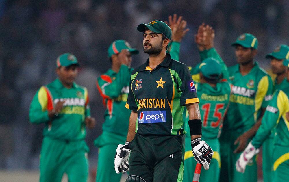 Pakistan’s Ahmed Shehzad walks back to the pavilion after his dismissal by Bangladesh’s Abdur Razzak during their match in the Asia Cup one-day international cricket tournament in Dhaka, Bangladesh.