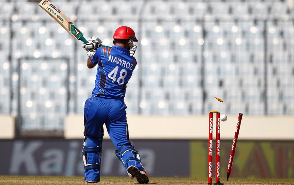 The bails fly off the wickets resulting in the dismissal of Afghan cricket player Nawroz Mangal during the Asia Cup one-day international cricket tournament against India in Dhaka, Bangladesh.