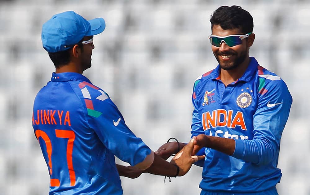 Ravindra Jadeja celebrates with his teammate Ajinkya Rahane after the dismissal of Afghan cricket player Asghar Stanikzai during the Asia Cup one-day international cricket tournament against India in Dhaka, Bangladesh.