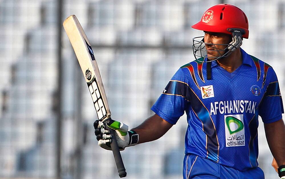 Afghanistan’s Samiullah Shenwari acknowledges the crowd after scoring fifty runs during their match against India in the Asia Cup one-day international cricket tournament in Dhaka, Bangladesh.