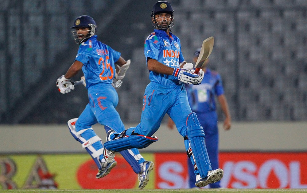Ajinkya Rahane and Shikhar Dhawan run between the wickets during their match against Afghanistan in the Asia Cup one-day international cricket tournament in Dhaka, Bangladesh.
