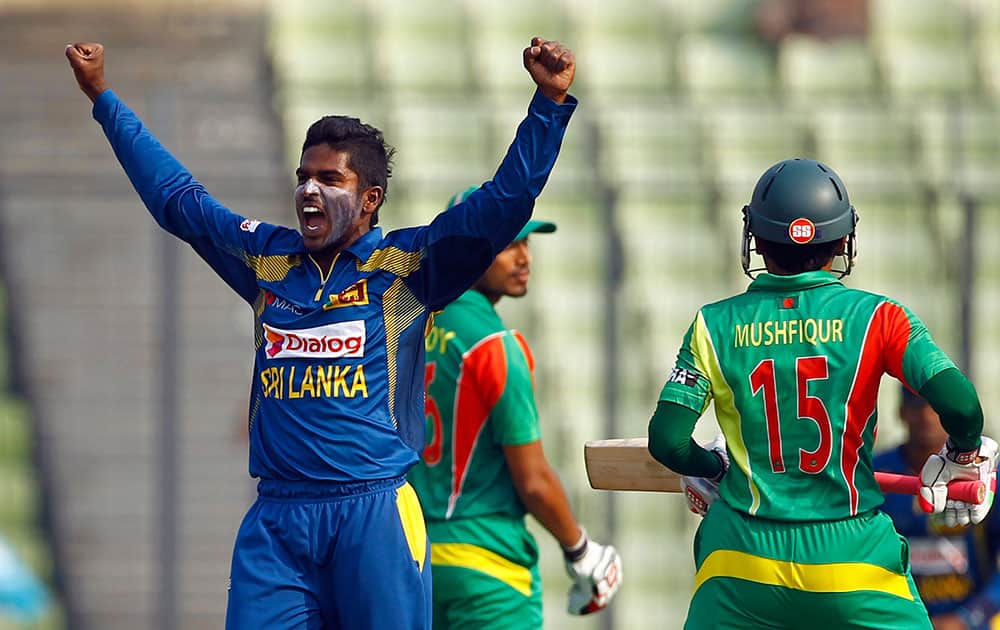 Sri Lanka’s Chaturanga de Silva, left, celebrates taking the wicket of Bangladesh’s captain Mushfiqur Rahim during the Asia Cup one-day international cricket tournament in Dhaka.