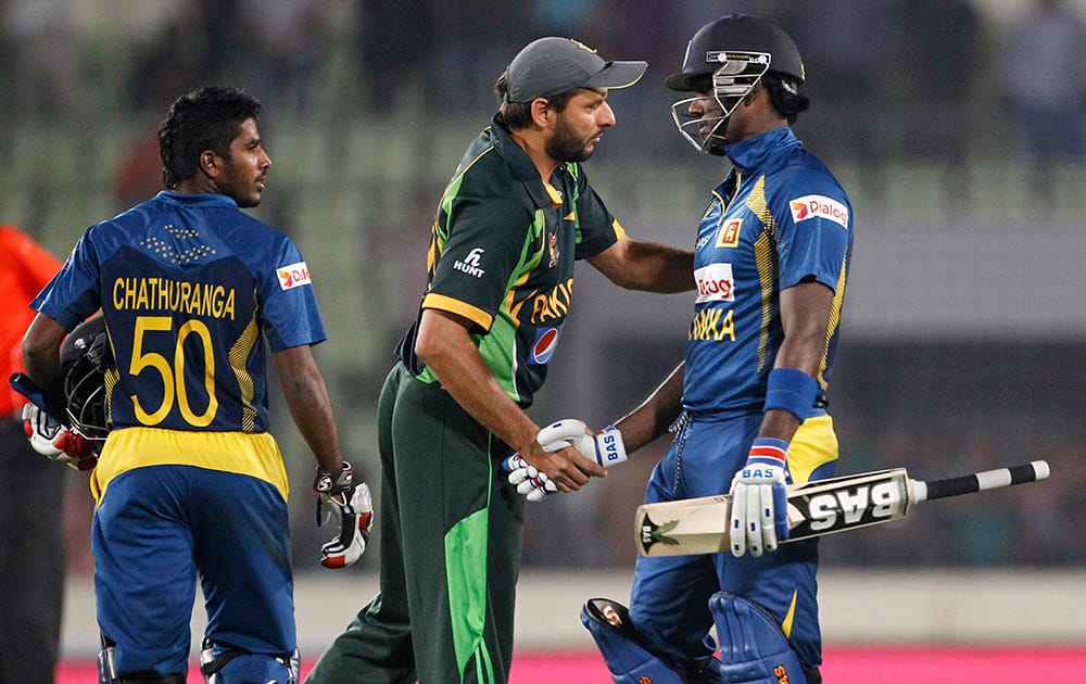 Sri Lanka’s captain Angelo Mathews, right, shakes hand with Pakistan’s Shahid Afridi after the Asia Cup final match in Dhaka, Bangladesh, Sri Lanka won the match.